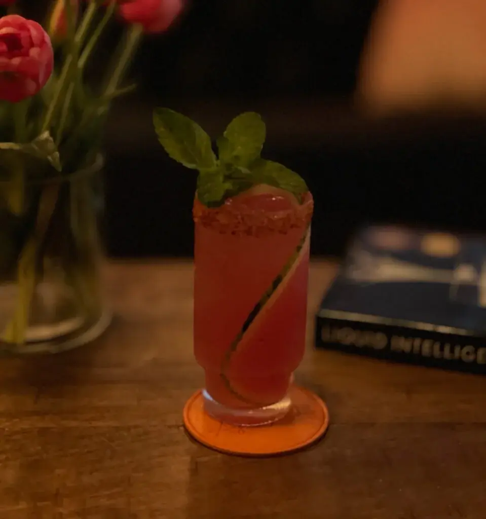 Watermelon High cocktail with a Tajín rim and fresh mint